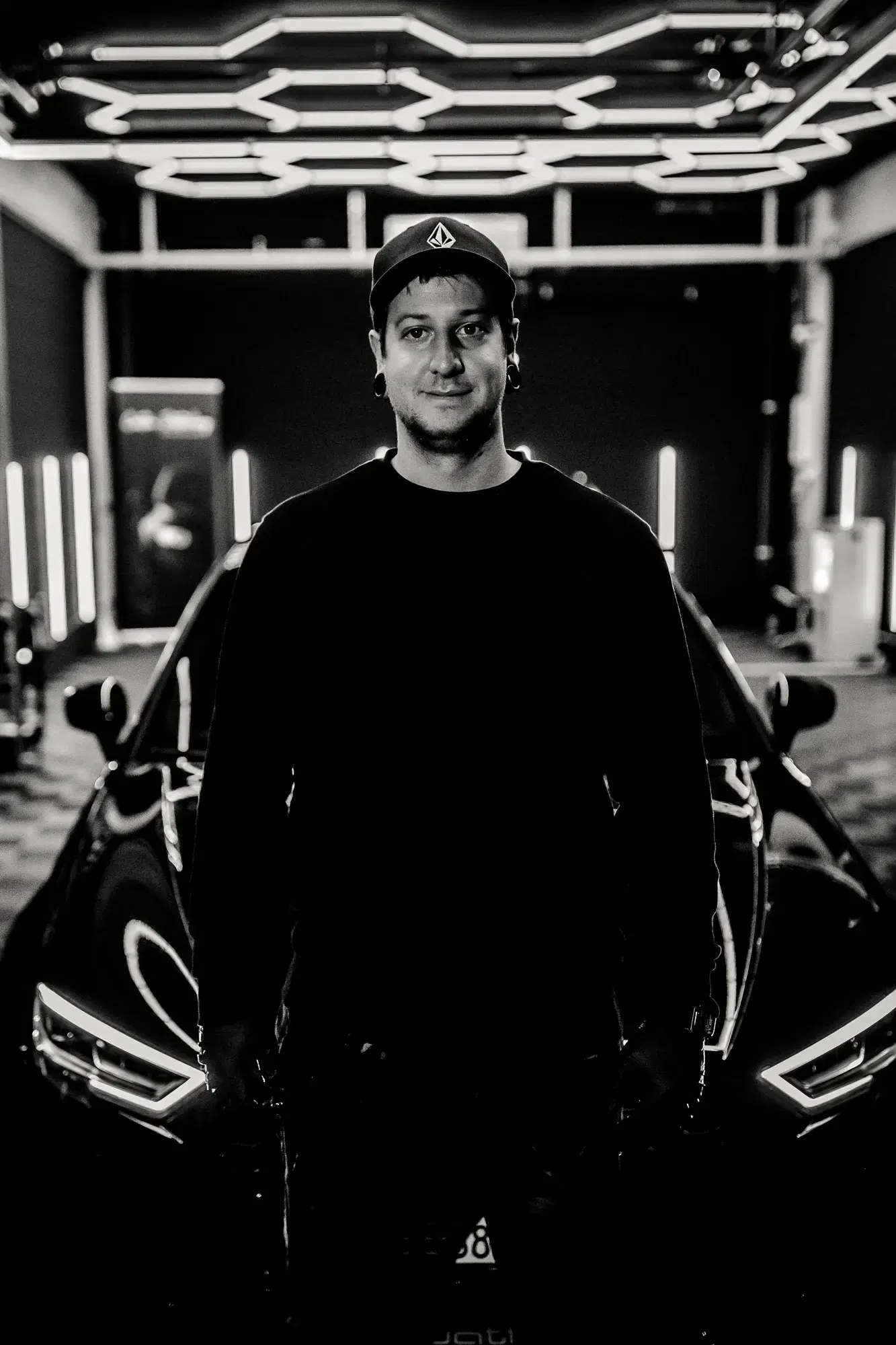 Detailing artisan meticulously polishing a luxury car in our premium studio